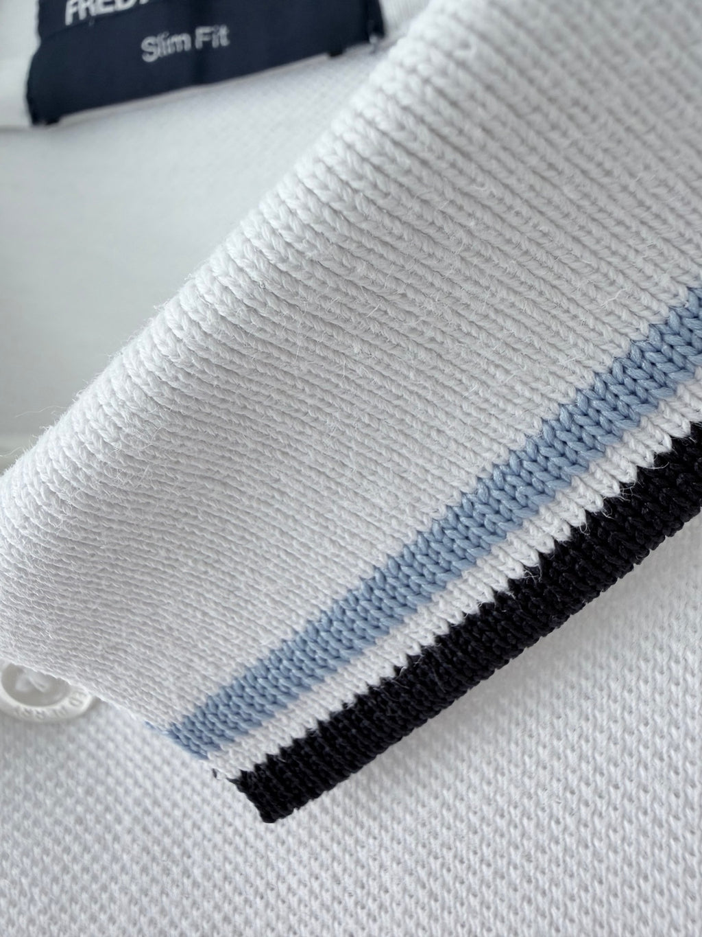 Fred Perry white polo sleeve detail